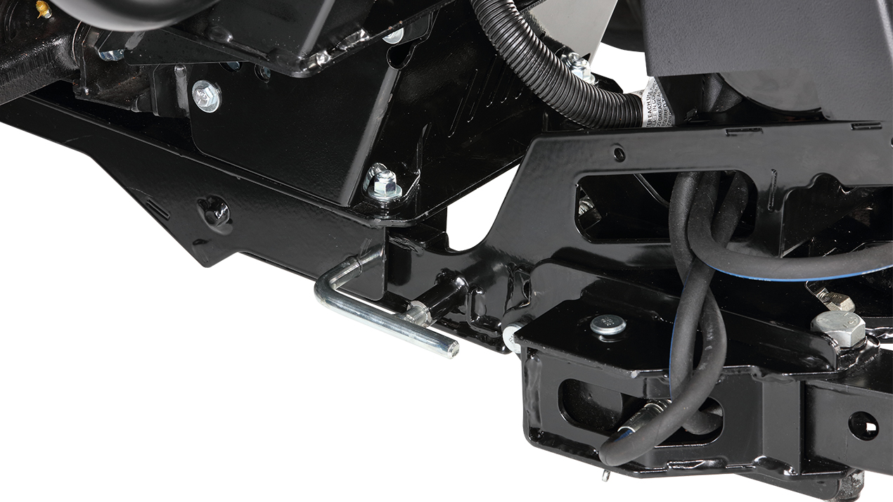 Close-up view of a black metal mechanical assembly with bolts, wires, and a silver pin, likely part of machinery or vehicle equipment.