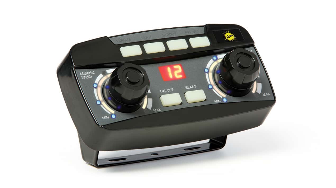 A black electronic control panel with two rotary knobs, a digital display showing 12, several white buttons, indicator lights, and a yellow icon on the top right, mounted on a bracket against a white background.