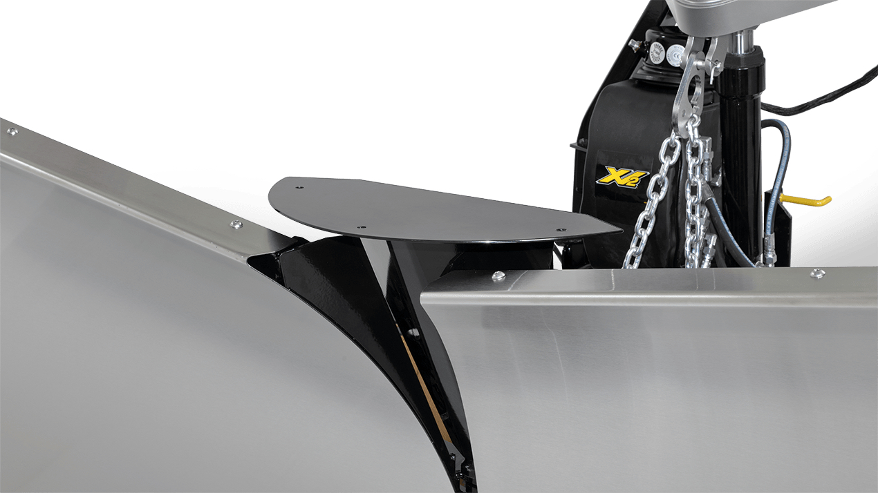 Close-up view of a metal snow plow blade with a hinge mechanism and attached chains, featuring a black mounting bracket and mechanical components.